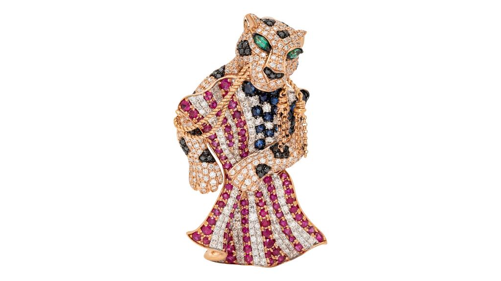 A patriotic leopard brooch mounted in 14-karat rose gold, pavé set with round brilliant cut diamonds, round mixed-cut sapphires, rubies and black diamonds, with marquise-cut emerald eyes, and stamped “14K EFFY” Madeleine K. Albright patriotic leopard brooch
